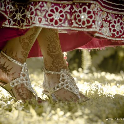 Close up of Indian bride's shoes dancing on green grass